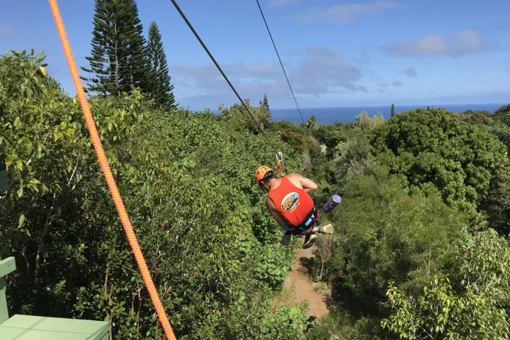Guy on a zipline in Maui