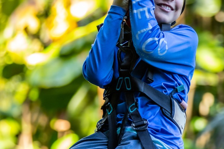 kid smiling while ziplining