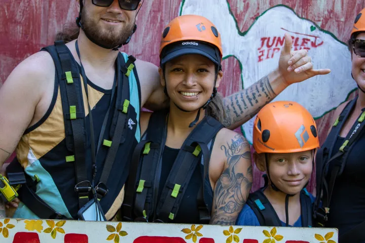 family posing with aloha sign