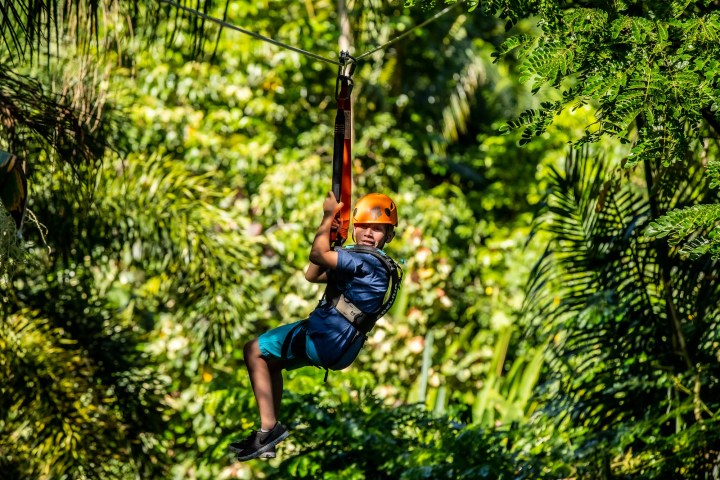kid ziplining looking at camera