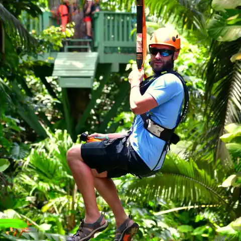 a man holding a banana tree